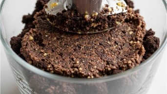 Chocolate cookie base pressed into dessert glass
